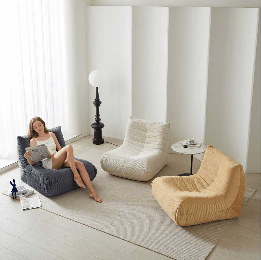 Three Matoresu CloudLounge chairs in gray, beige, and yellow in a minimalist space