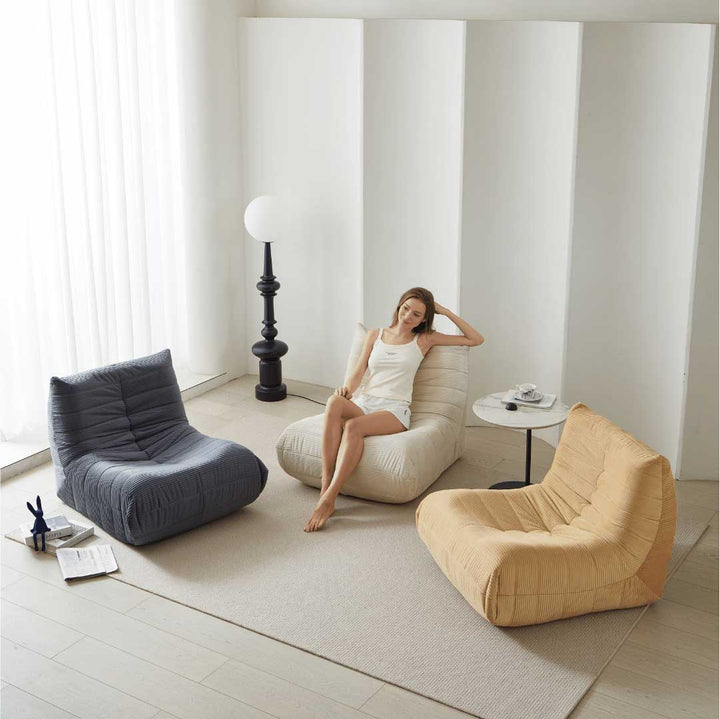 Life style view of beige Matoresu CloudLounge chair with model relaxing