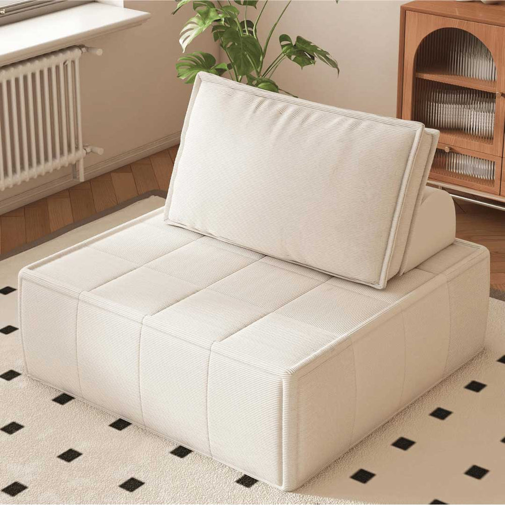 Cozy beige modular floor chair with backrest in a sunlit room with indoor plants