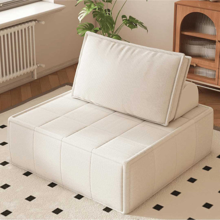 Cozy beige modular floor chair with backrest in a sunlit room with indoor plants