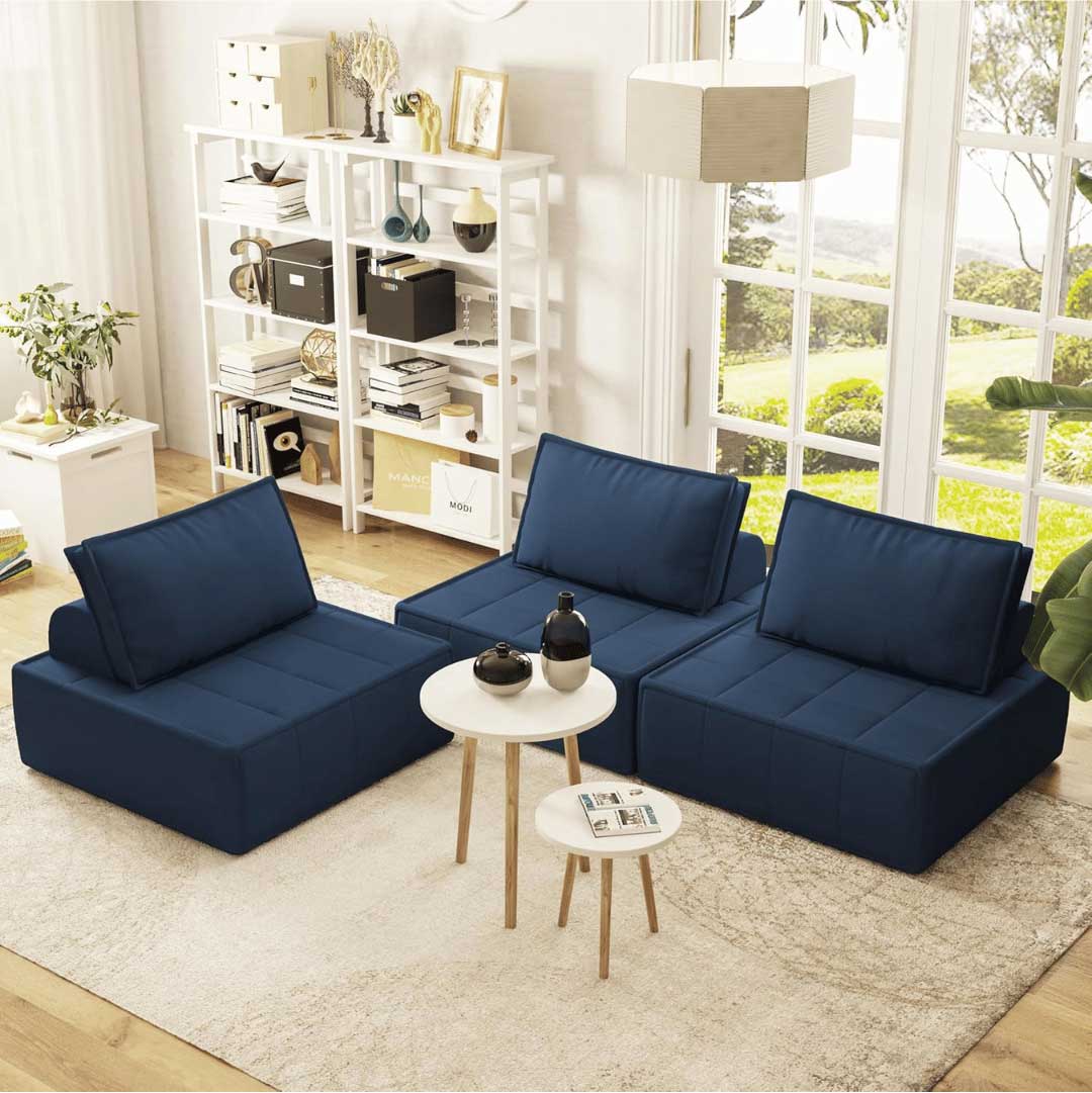 Three navy blue modular armless chairs arranged in a modern living room