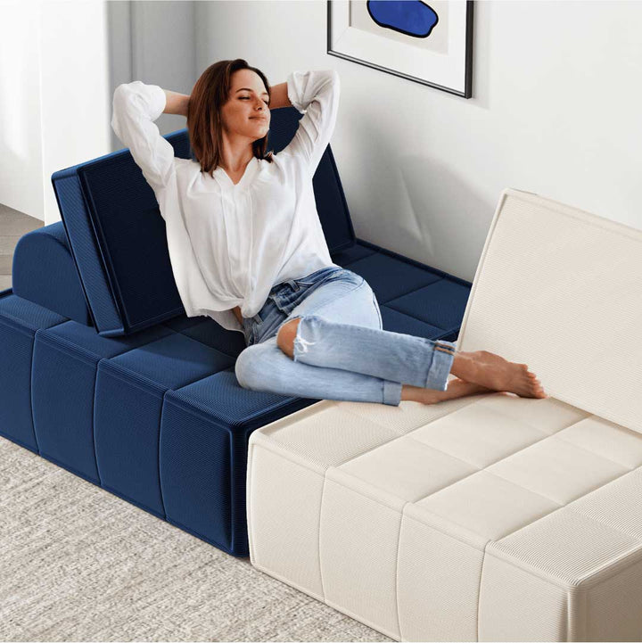 Woman relaxing on a mix of beige and navy blue modular armless chairs in a cozy room